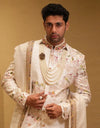 A man wearing a Royal Ivory Tapestry Sherwani Set from The HUB.