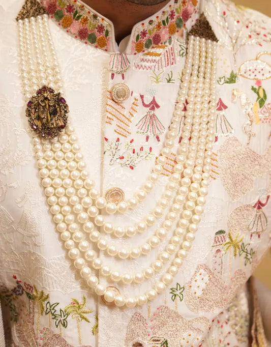 A man wearing a Royal Ivory Tapestry Sherwani Set from The HUB.