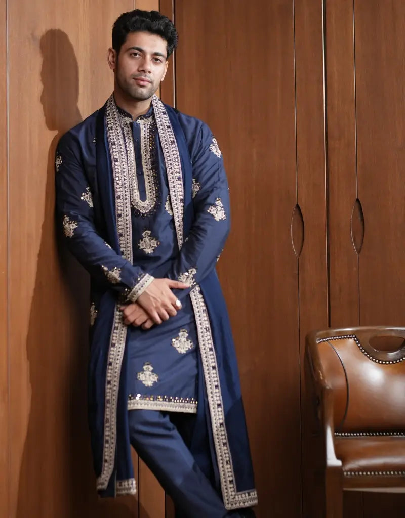 A man wearing a Midnight Majesty Embroidered Navy Blue Kurta Set from The HUB.