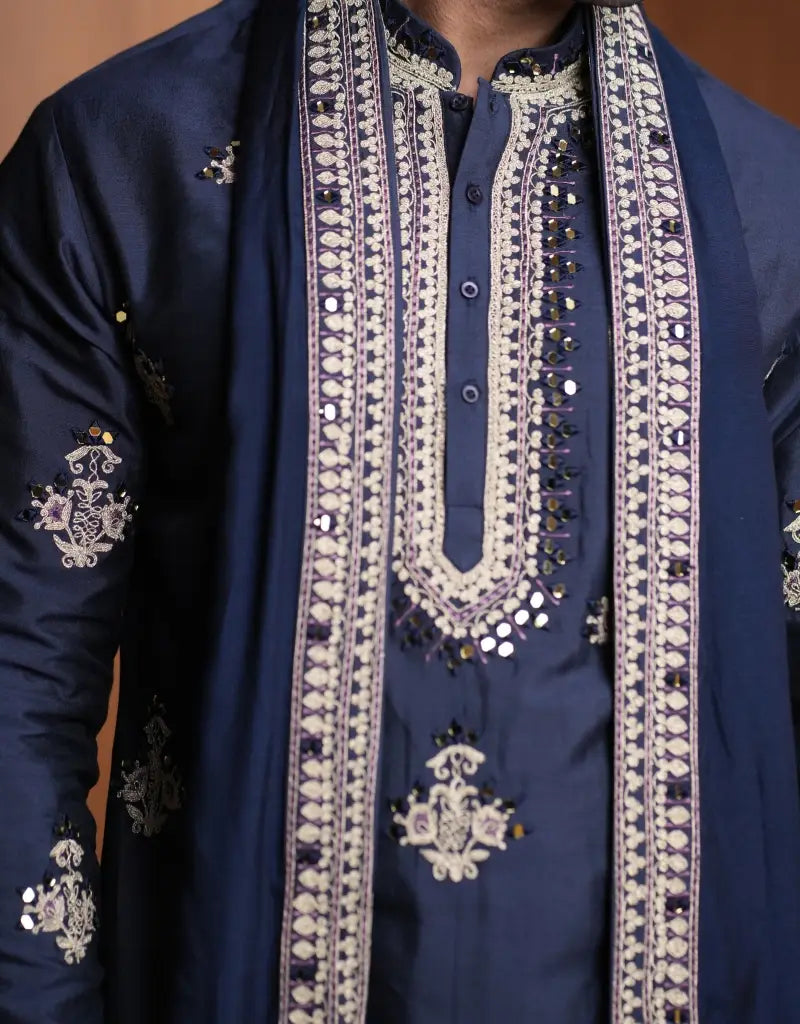 A man wearing a Midnight Majesty Embroidered Navy Blue Kurta Set from The HUB.