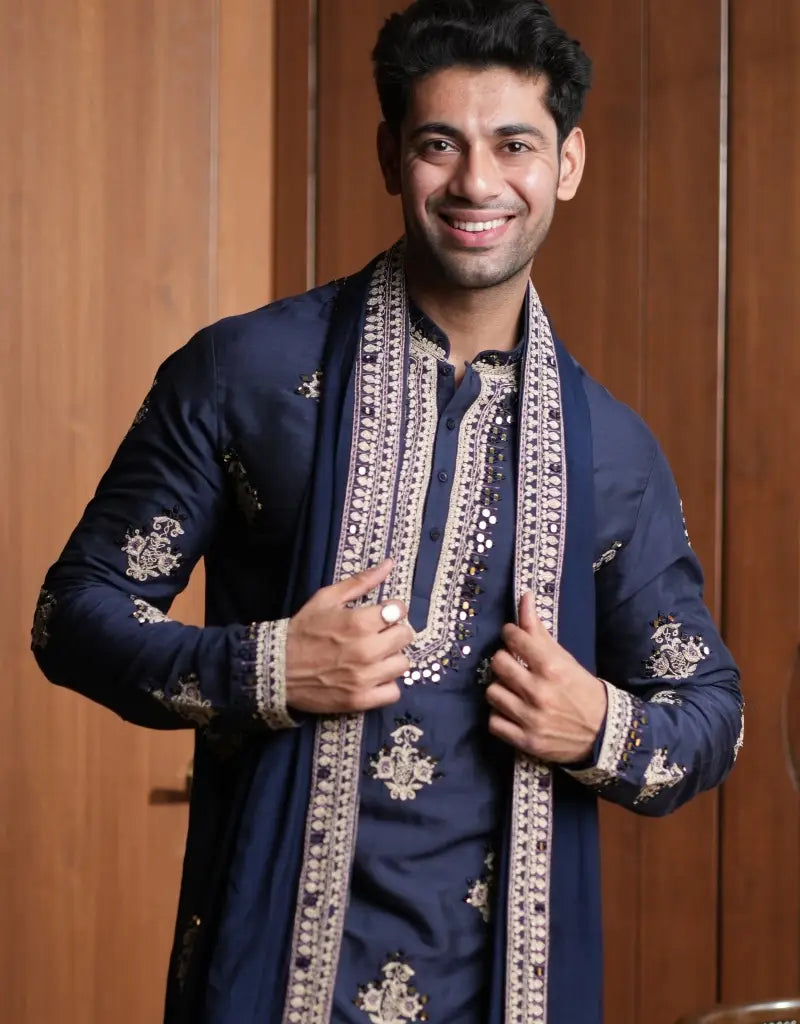 A man wearing a Midnight Majesty Embroidered Navy Blue Kurta Set from The HUB.