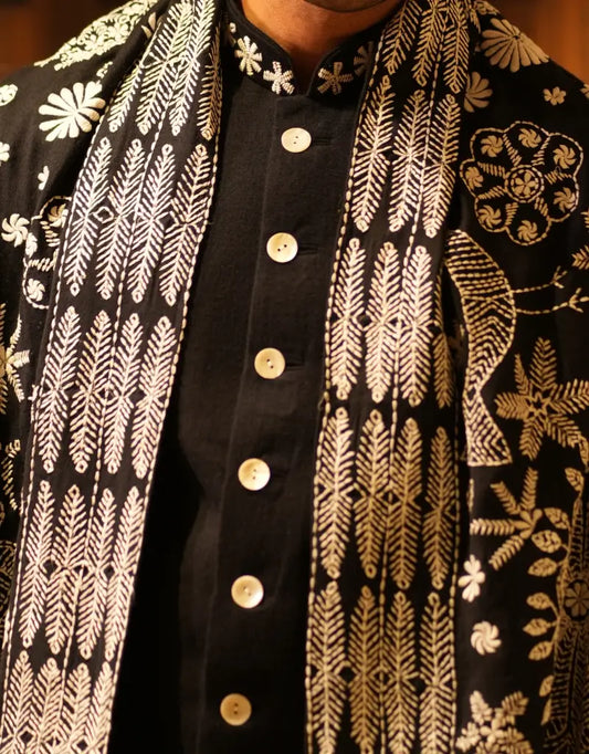A man wearing the black achkan sherwani of The Hub