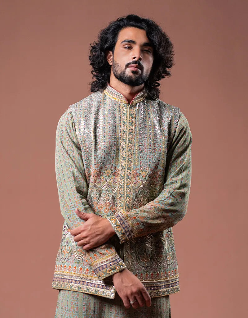 Man wearing a traditional embroidered Kalamkari Gotta Bandi Kurta Set against a brown background
