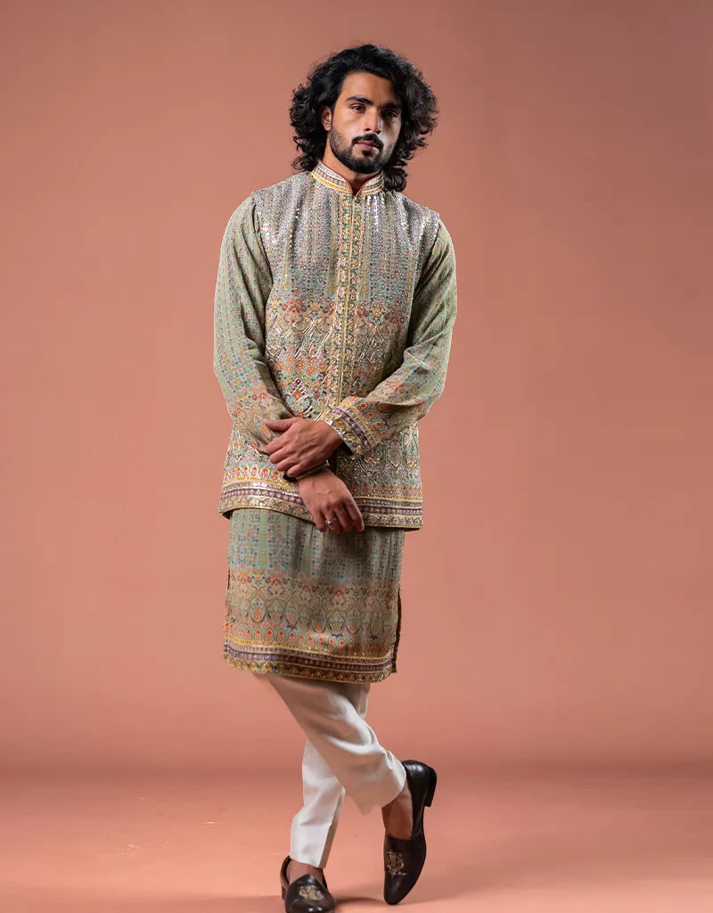 Man wearing a traditional Kalamkari Gotta Bandi Kurta Set with intricate patterns on a brown background