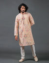 Man wearing a patterned Khadi Mirror Work Kurta with white pants against a gray background