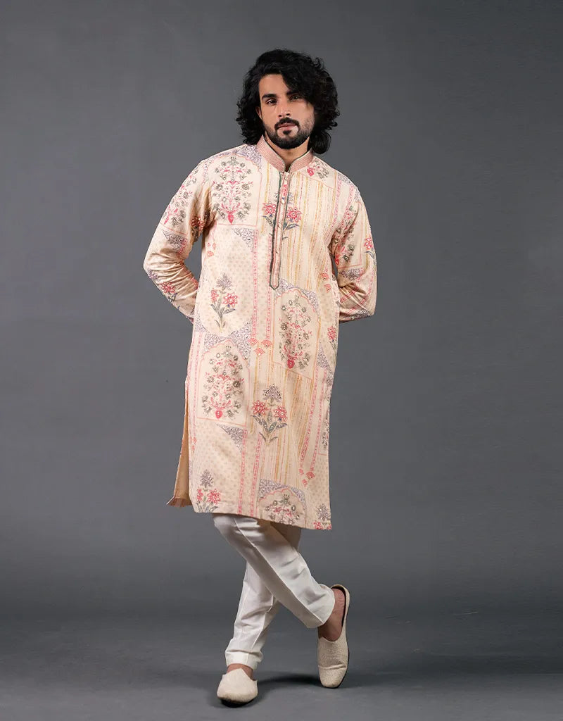 Man wearing a patterned Khadi Mirror Work Kurta  with white pants against a gray background