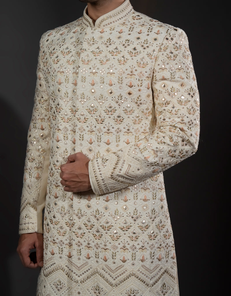 A man wearing a three-piece sherwani with leather appliqué & thread work in ivory from The HUB.