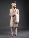 A man wearing a four-piece leather appliqué work sherwani in onion pink from The HUB.