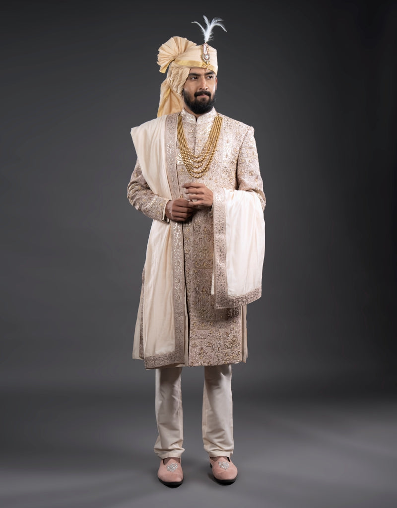 A man wearing a four-piece leather appliqué work sherwani in onion pink from The HUB.