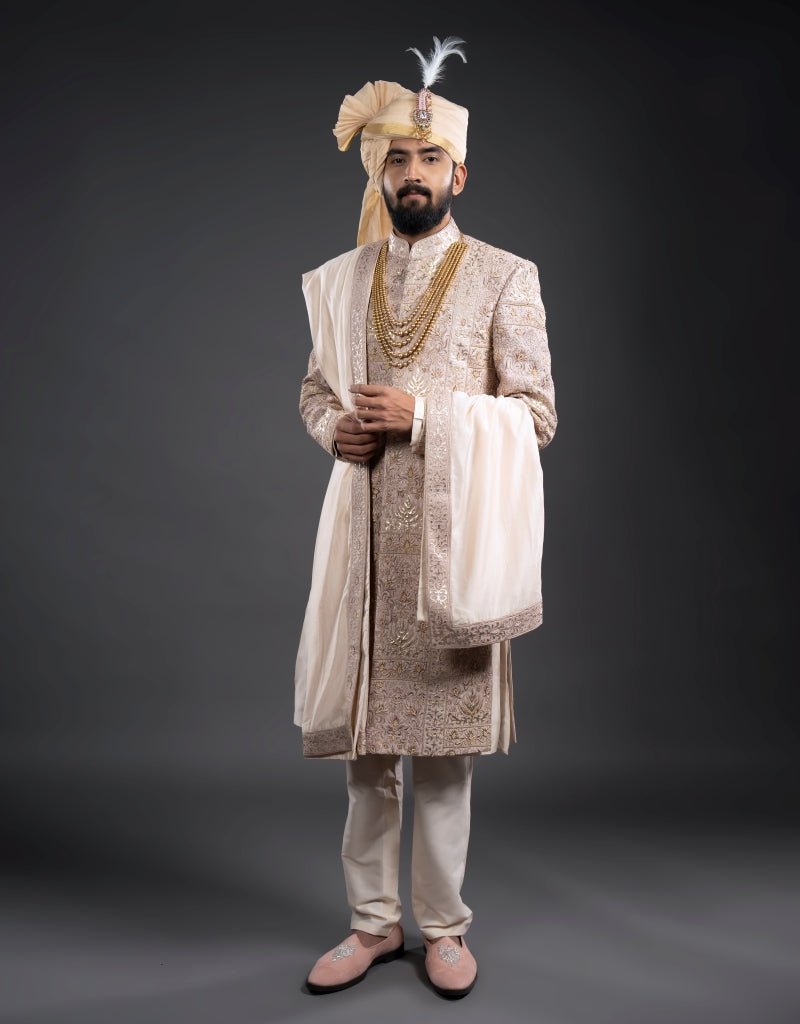 A man wearing a four-piece leather appliqué work sherwani in onion pink from The HUB.