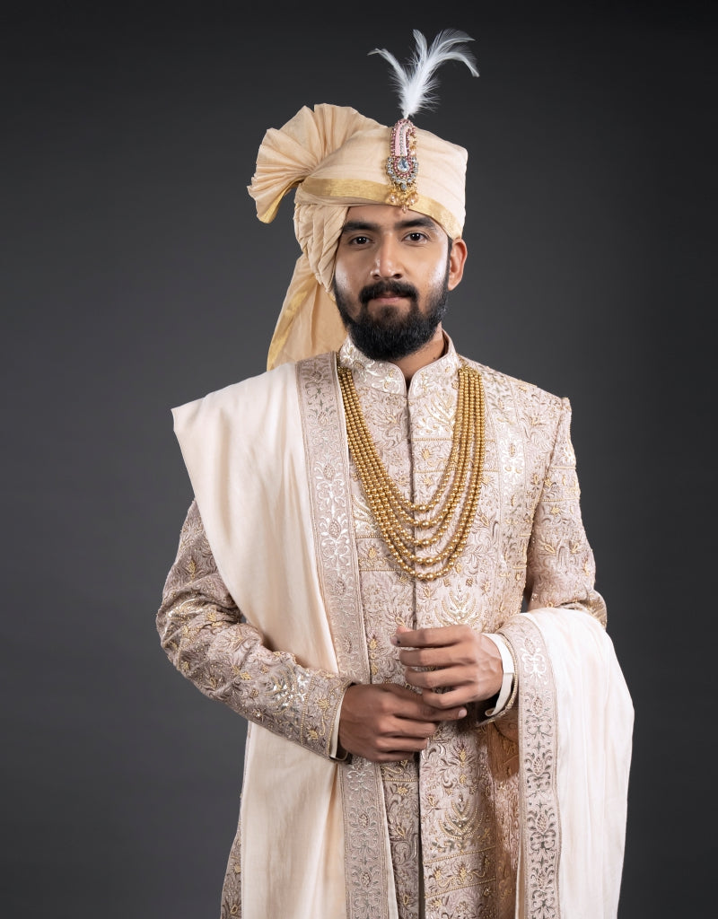 A man wearing a four-piece leather appliqué work sherwani in onion pink from The HUB.