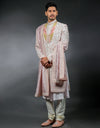 A man wearing the three-piece handwork with digital print sherwani in pink from The HUB.