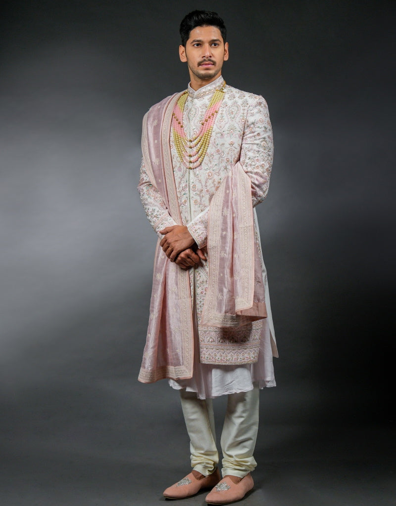 A man wearing the three-piece handwork with digital print sherwani in pink from The HUB.