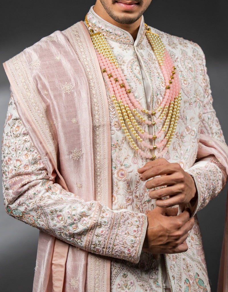 A man wearing the three-piece handwork with digital print sherwani in pink from The HUB.