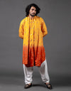 Man wearing a yellow to orange gradient kurta with white pants on a gray background