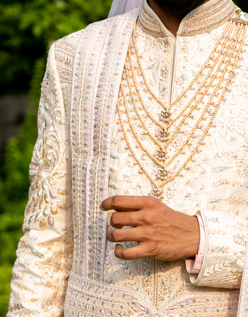 A man wearing a five-piece Diamond Zardozi and Kardana Handwork Sherwani in cream from The HUB.