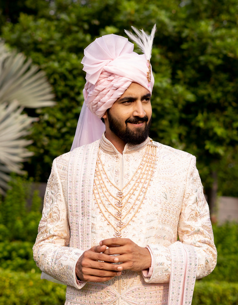 A man wearing a five-piece Diamond Zardozi and Kardana Handwork Sherwani in cream from The HUB.