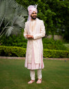 A man wearing a five-piece Diamond Zardozi and Kardana Handwork Sherwani in cream from The HUB.