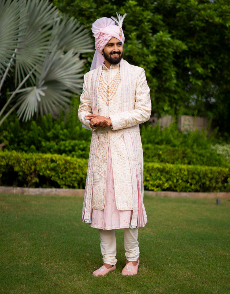 A man wearing a five-piece Diamond Zardozi and Kardana Handwork Sherwani in cream from The HUB.
