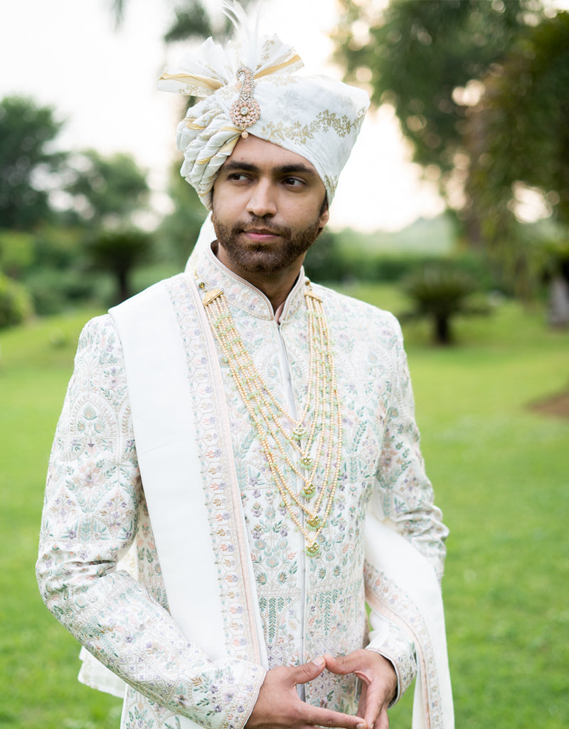 A man wearing the four-piece Nysa Silk Sherwani in Ivory from The HUB.