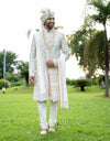A man wearing the four-piece Nysa Silk Sherwani in Ivory from The HUB.