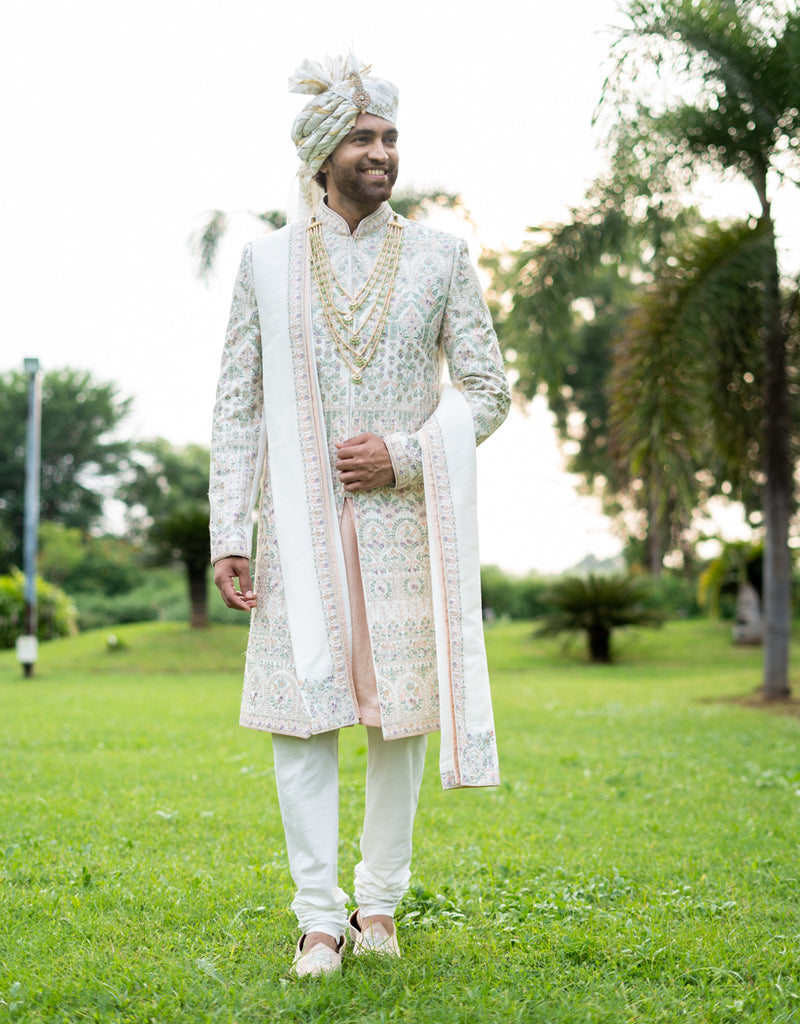 A man wearing the four-piece Nysa Silk Sherwani in Ivory from The HUB.