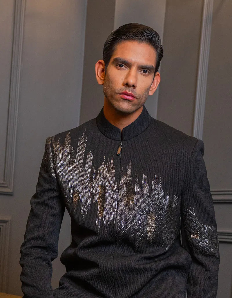 Man wearing a black Classic Bandhgala Indo Western outfit with decorative elements against a neutral background