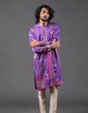 Man wearing a purple embroidered kurta against a gray background