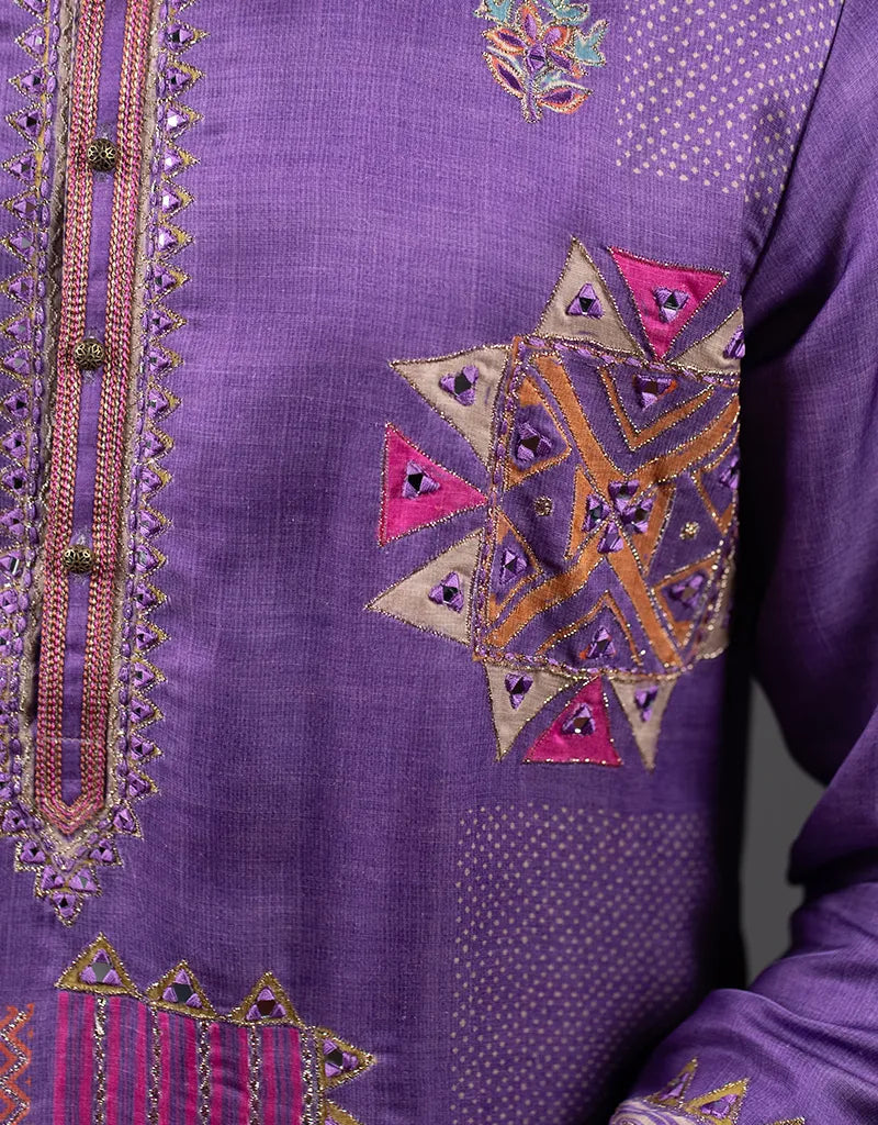 Purple fabric with intricate geometric embroidery
