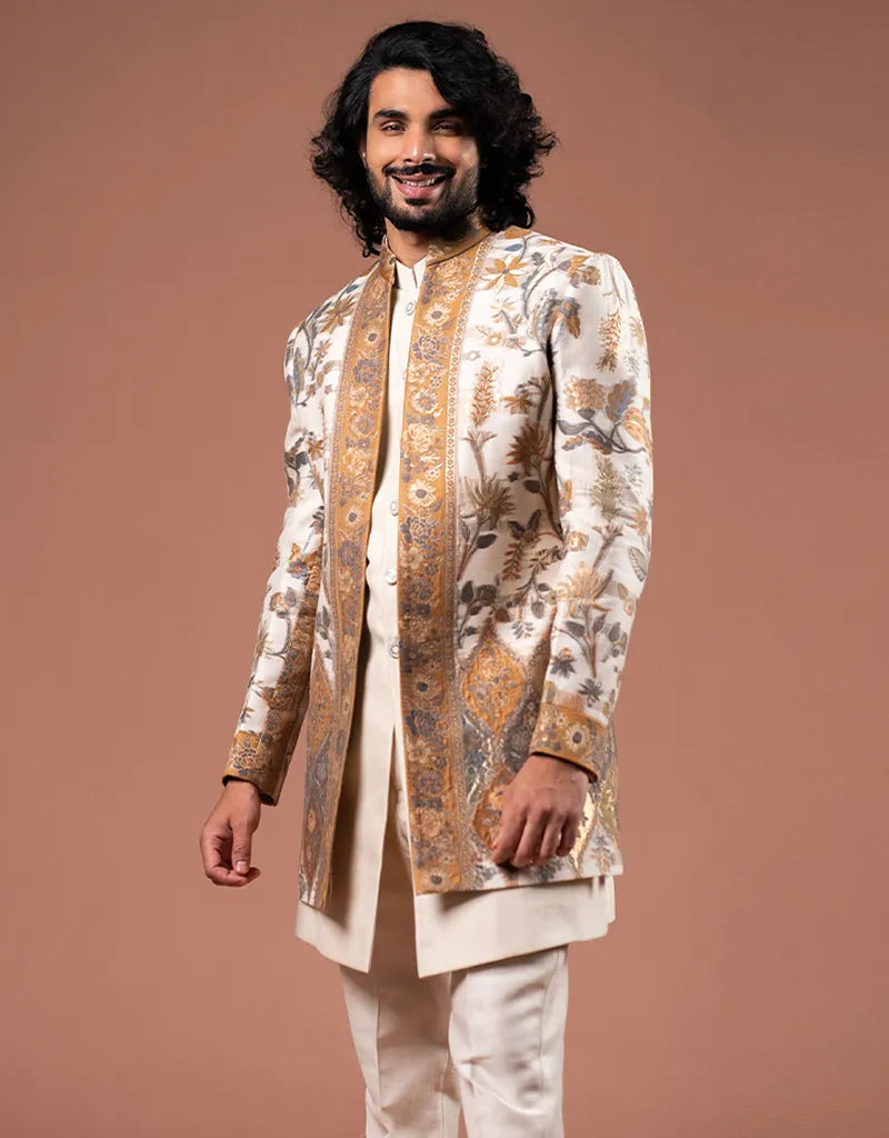 Man wearing a traditional embroidered Zari Jamawar Silk Kurta Set with a brown background