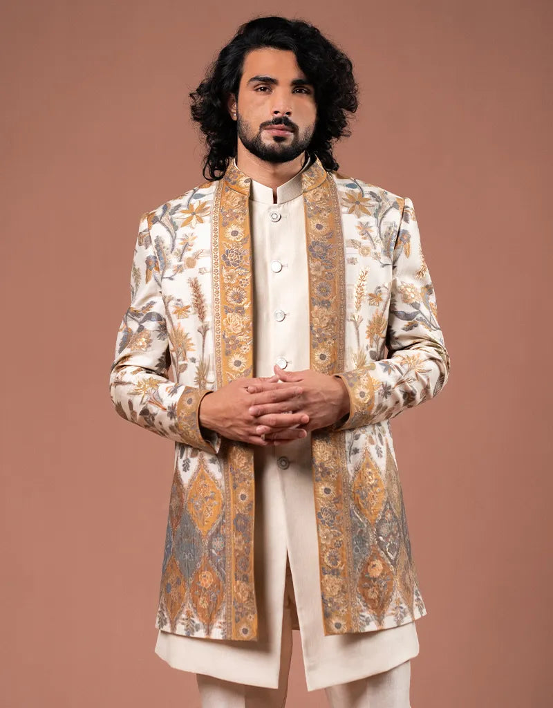 Man wearing a traditional embroidered Zari Jamawar Silk Kurta Set against a brown background