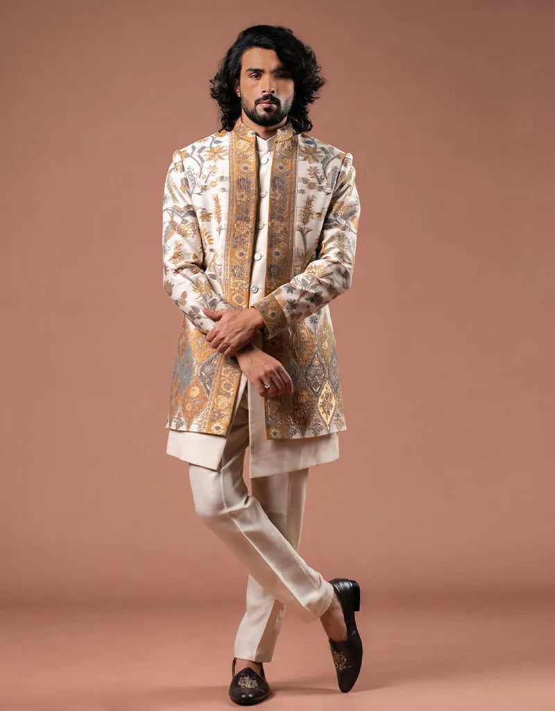 Man wearing a traditional embroidered Zari Jamawar Silk Kurta Set against a brown background