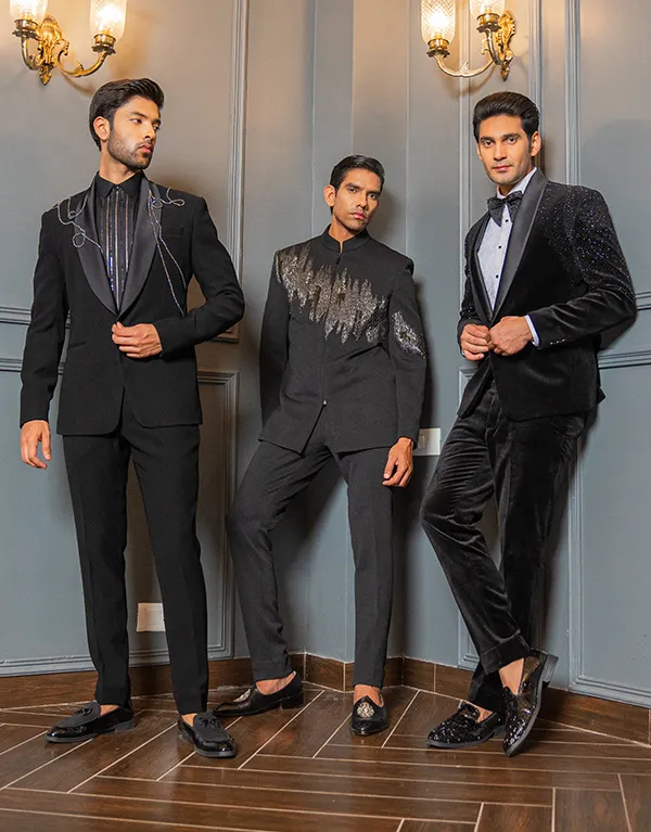 three men wearing three piece black suit